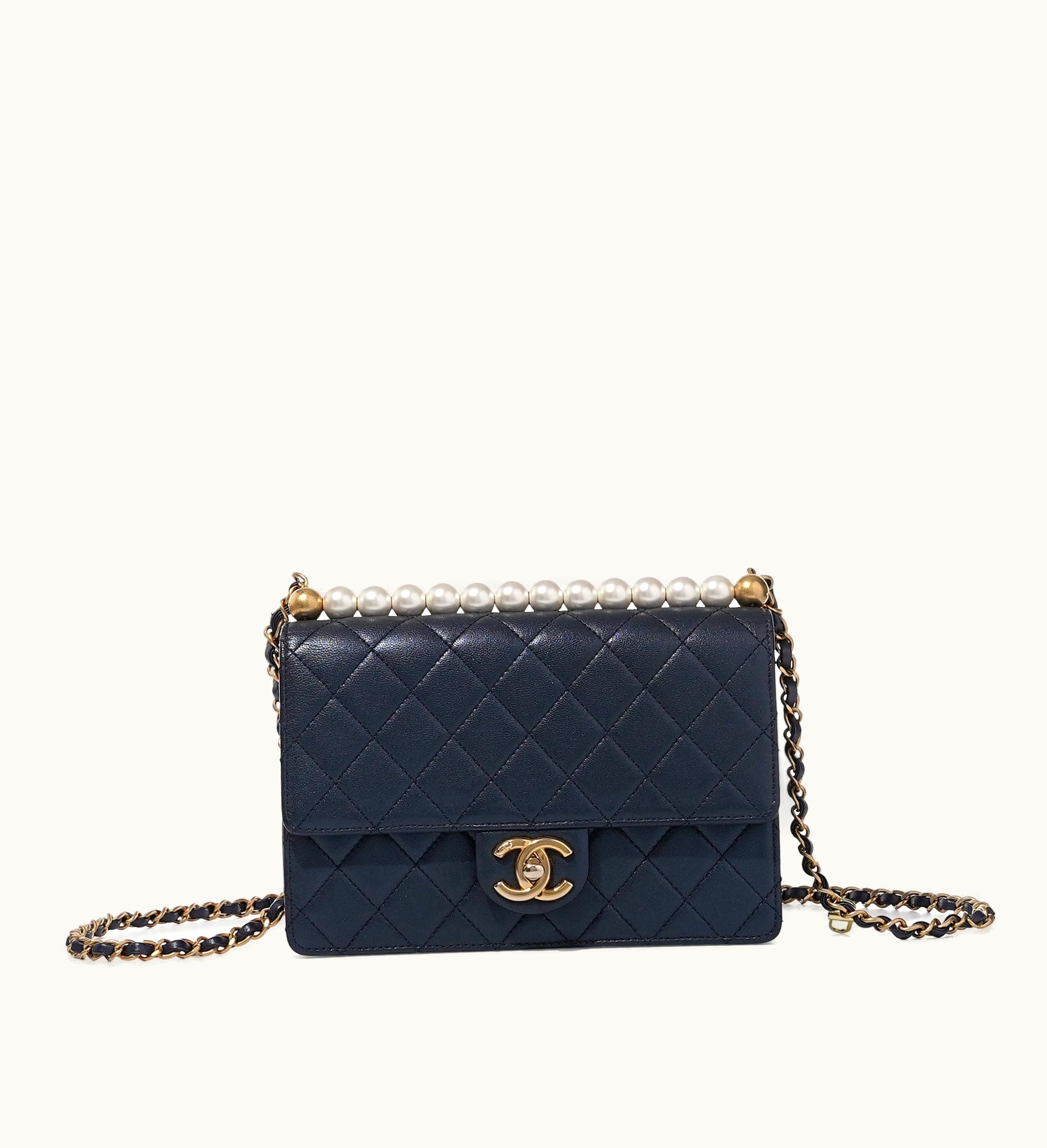 Chanel Chanel Quilted Lambskin Flap Bag with Navy undertones, adorned with Imitation Pearls and complemented by Gold Hardware