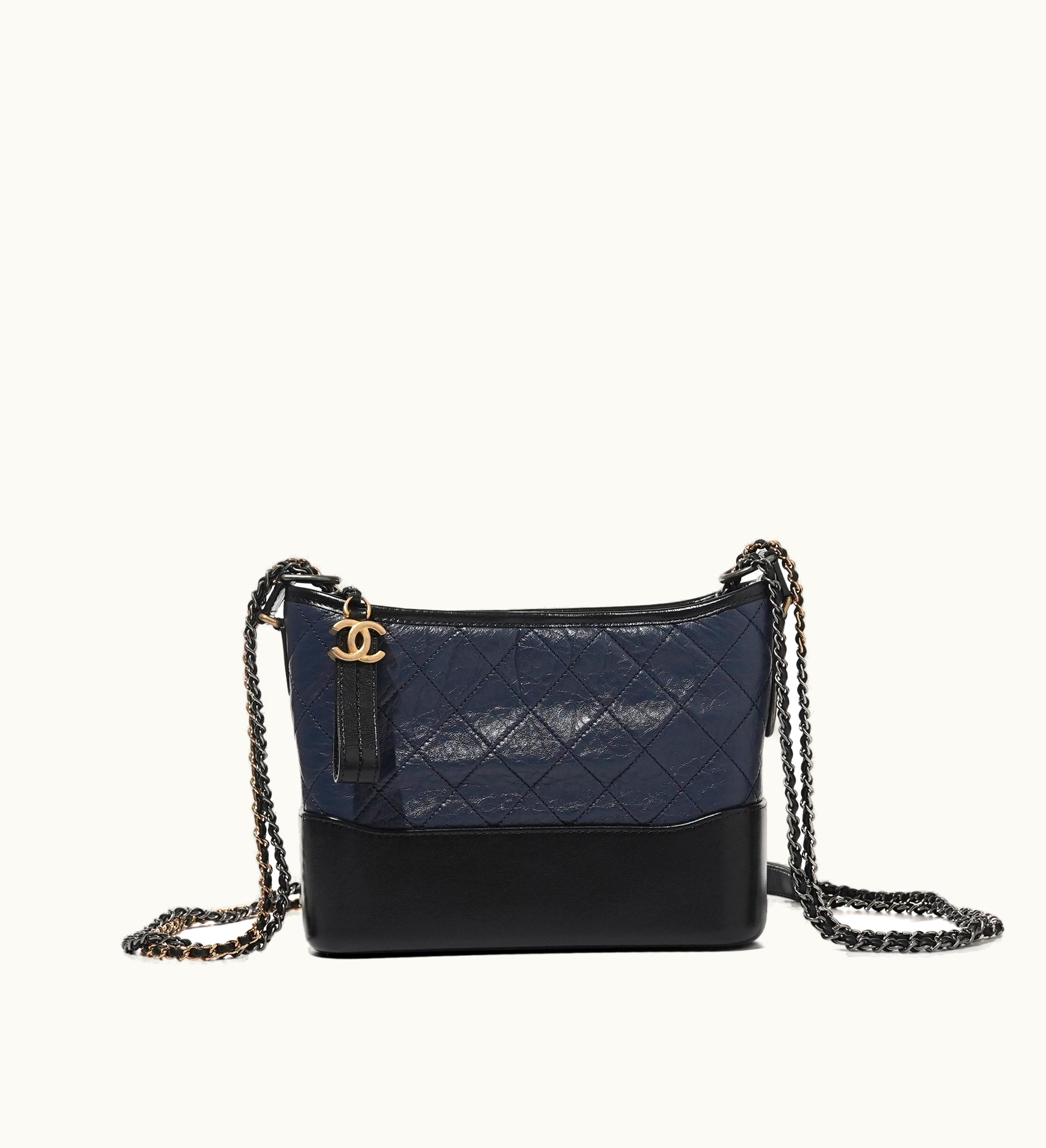 Chanel Chanel 2020 brings the exquisite Chanel Navy and Black Quilted Calfskin Medium Gabrielle Hobo Bag. Adorned with elegant Gold and Ruthenium Hardware, this bag is an absolute gem